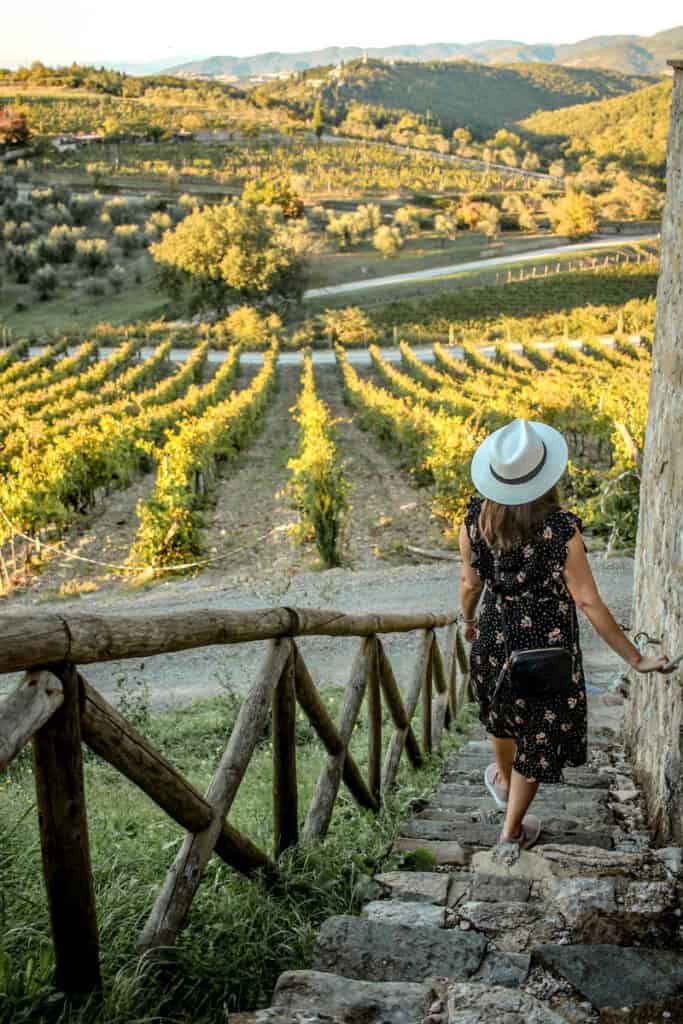 girl walking down staircase to Tuscany Wine Fields