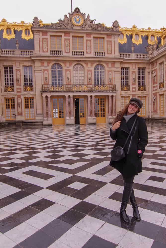 girl standing in front of Palace of Versailles
