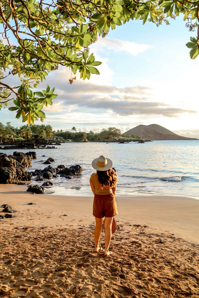 girl standing on beach admiring the ocean in Maui Hawaii