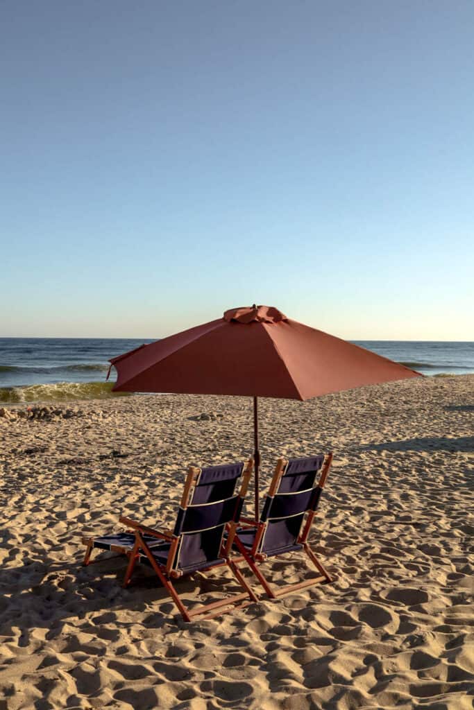 two chairs and an umbrella on beach in Montauk New York