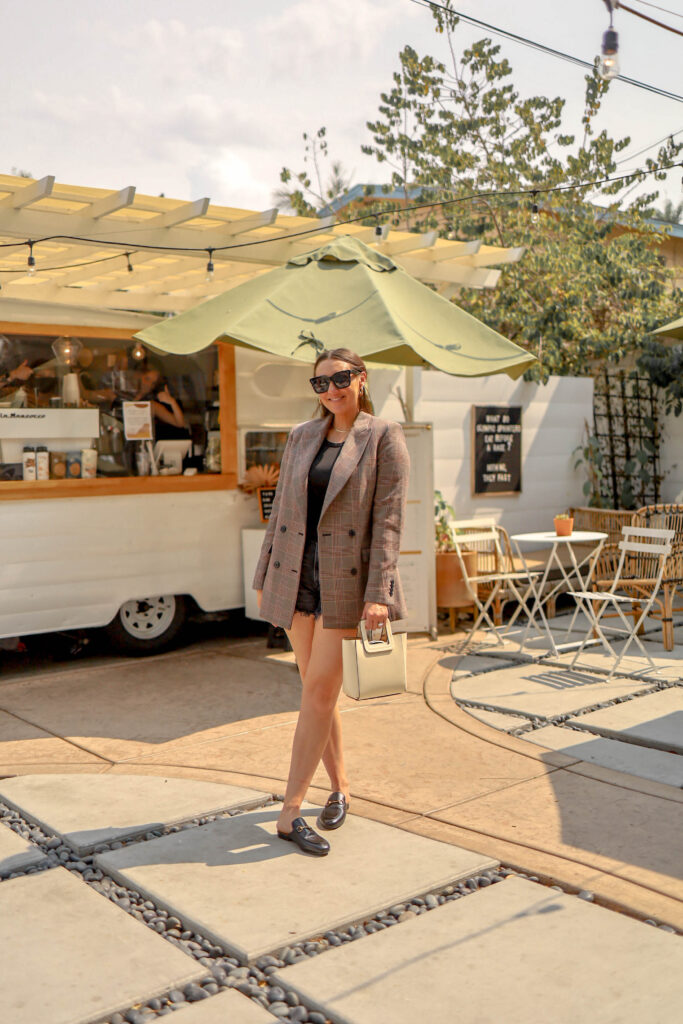 girl wearing gucci mules and plaid blazer