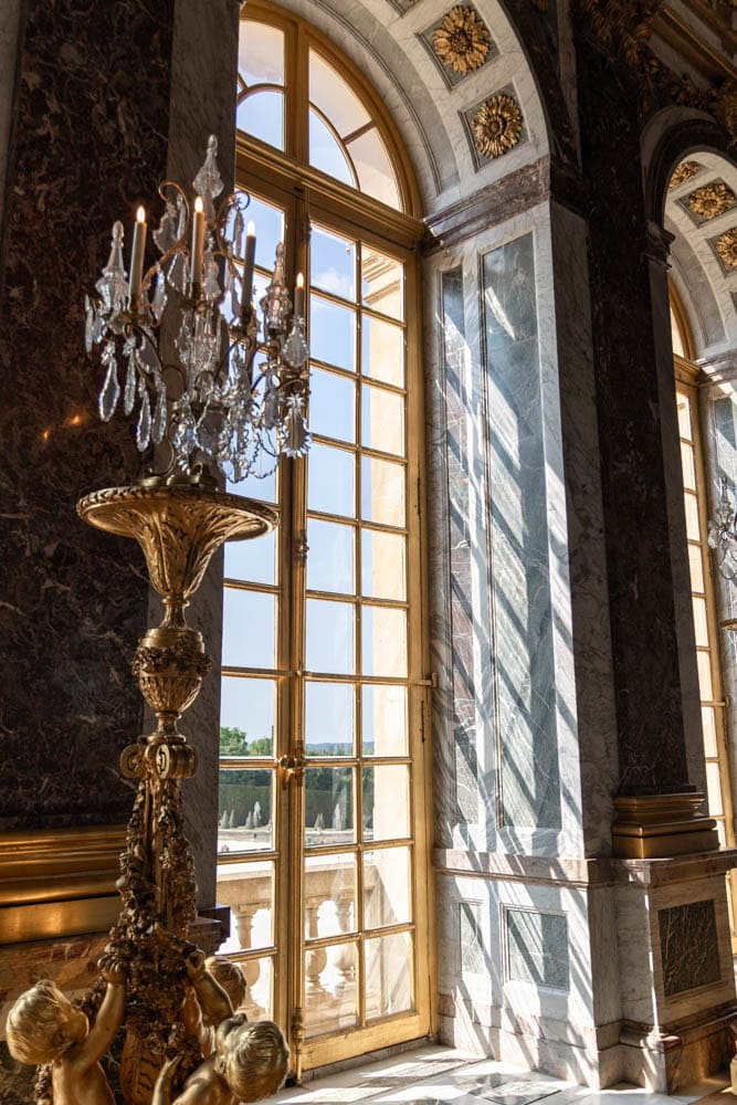 intricate french doors surrounded by marble and gold statues