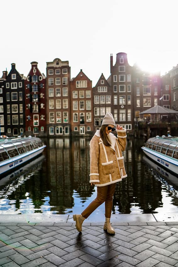 girl standing in front of the Dancing Houses in Amsterdam