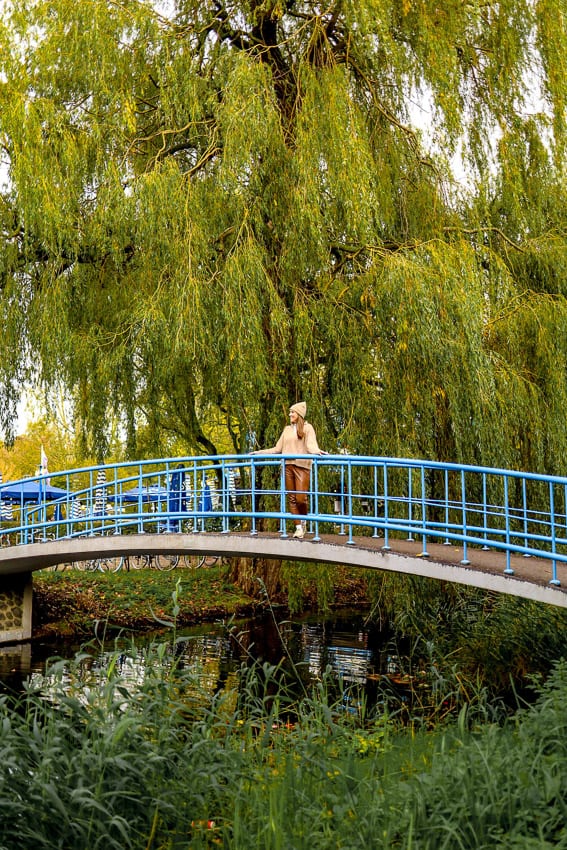 girl standing on blue bridge in Vondelpark