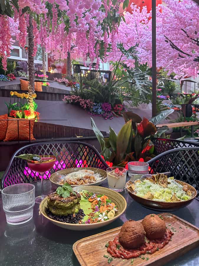 arancini, steak cauliflower, and bolognese tablescape inside insideOUT restaurants spring oasis experience