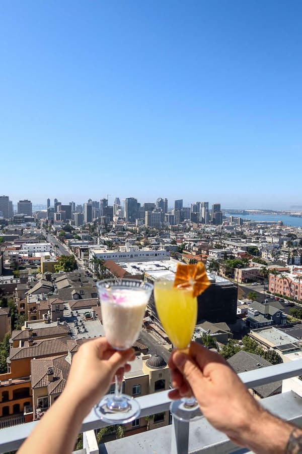 two cocktails in front of Mister A's View overlooking all of downtown San Diego
