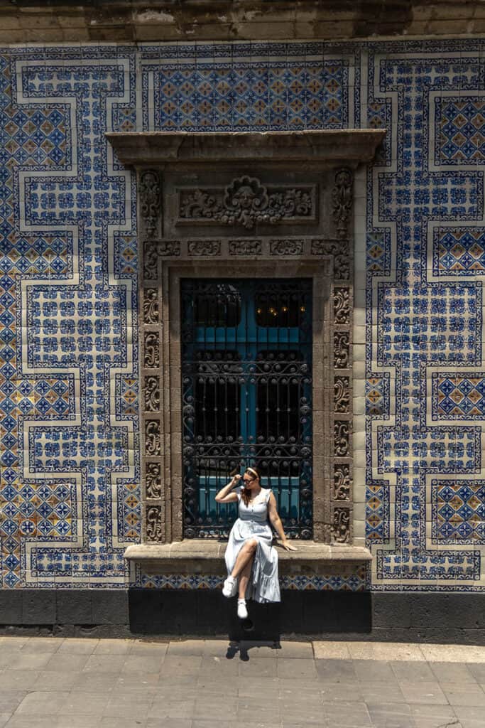 girl sitting on window sill at House of Tiles in Mexico City