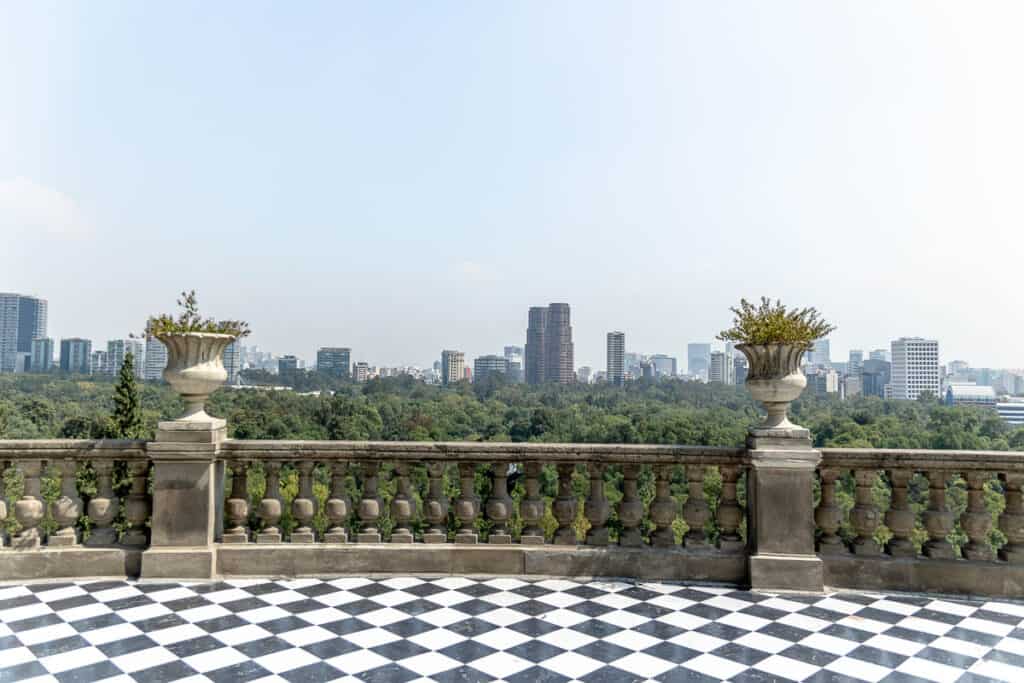 Chapultepec Castle balcony with black and white tiles and a CDMX skyline view