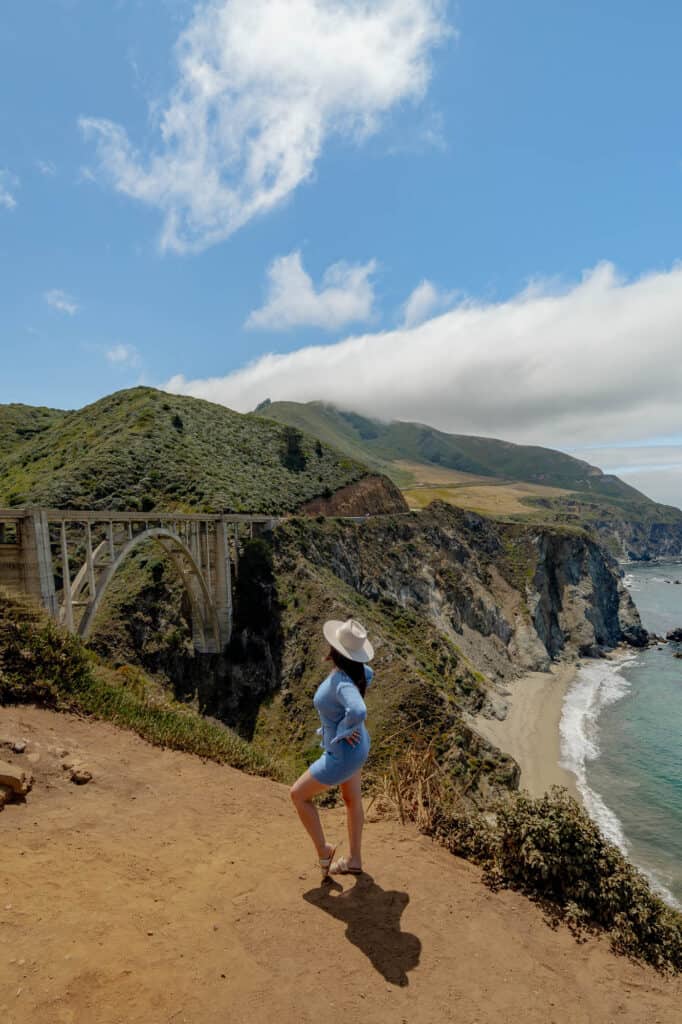 girl in blue admiring the view from Bixby Bridge in Big Sur
