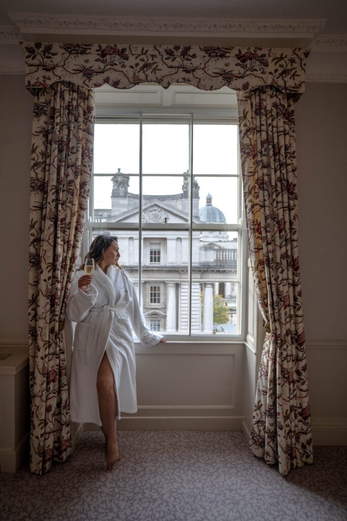 girl standing in window of Merrion Hotel in Ireland