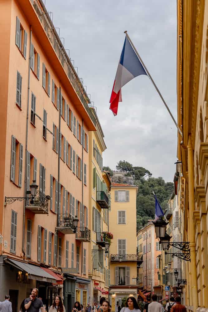 French flag on a colorful building in Old Town Nice