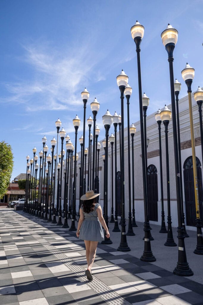 girl standing in front of art installation in La Paz