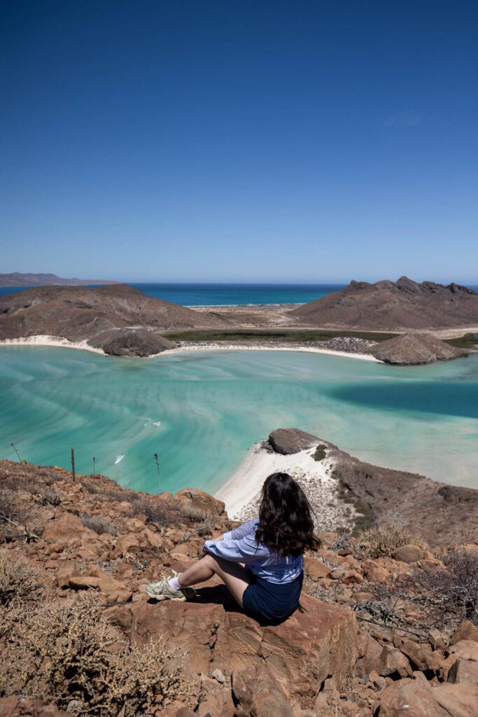girl sitting atop summit overlook Balandra Bay