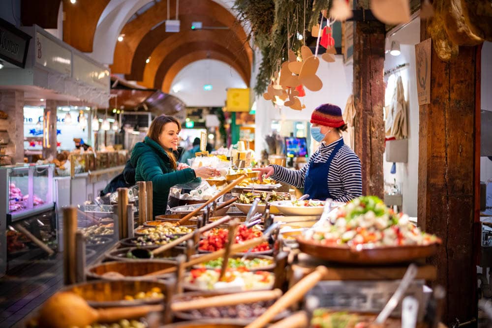 spices and woman shopping at the english market in cork