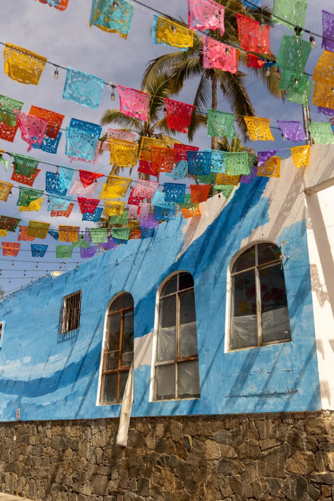 colorful flags lining the street in downtown Todos Santos