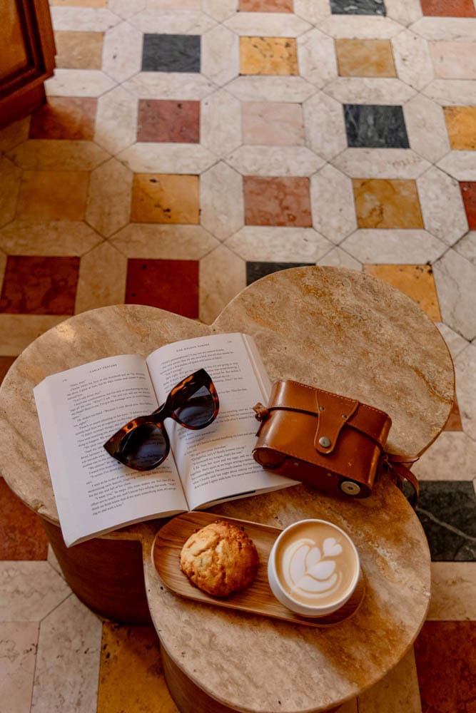 checkered floors, a book, and coffee in Paris coffee shop