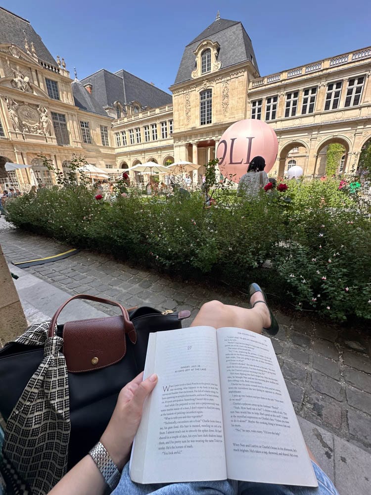 reading a book in the museum courtyard with Parisian Architecture