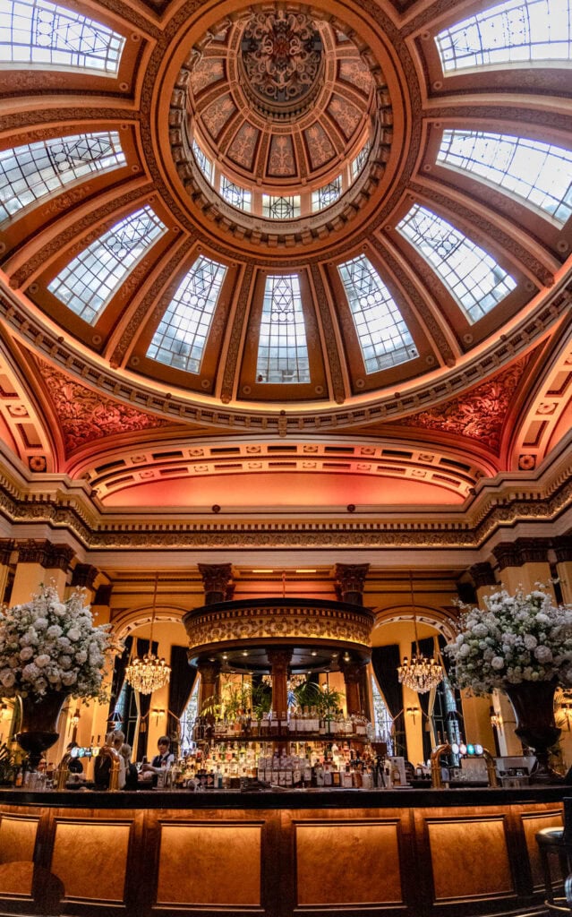 Elegant restaurant with stunning domed glass ceiling and luxurious bar ambiance.