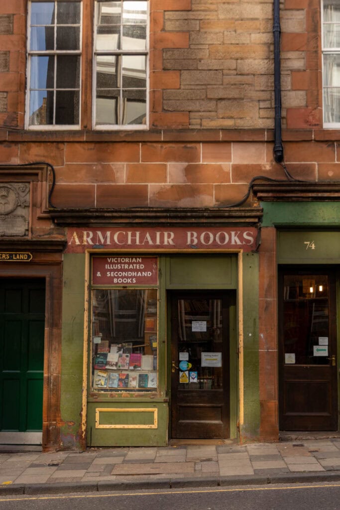 Victorian bookstore storefront with secondhand books display in historic building.
