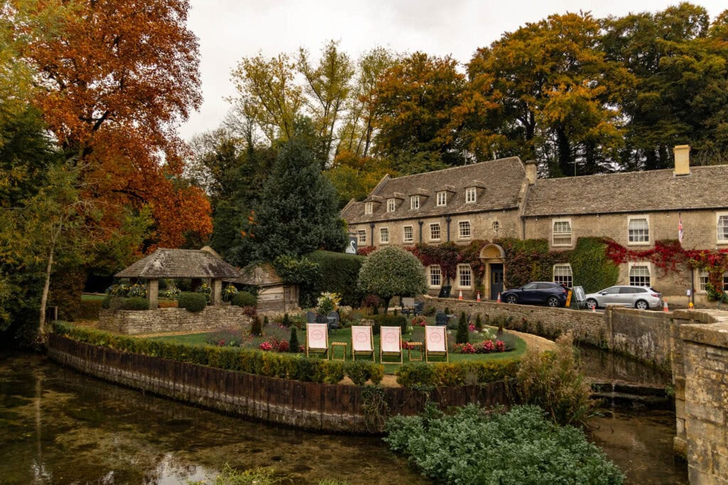Cozy historic inn with fall colors and lush landscaping, perfect for relaxing countryside getaway.