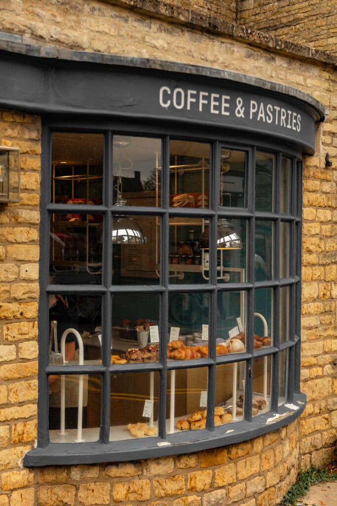 Charming coffee shop with fresh pastries and baked goods inside a rustic brick building.
