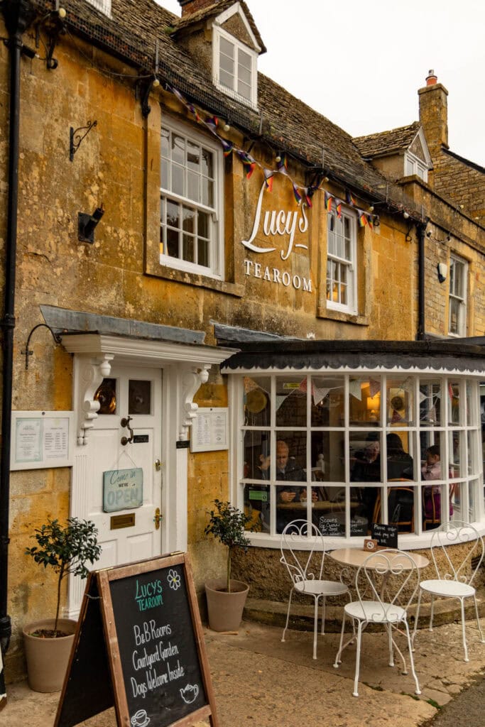 Cozy stone building with inviting outdoor seating at Lucy’s Tearoom, perfect for travel and cultural exploration.