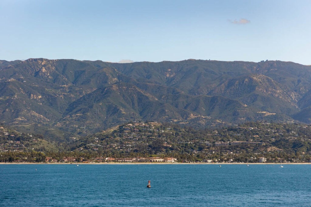 Beautiful lake with calm waters and mountain range in the background.