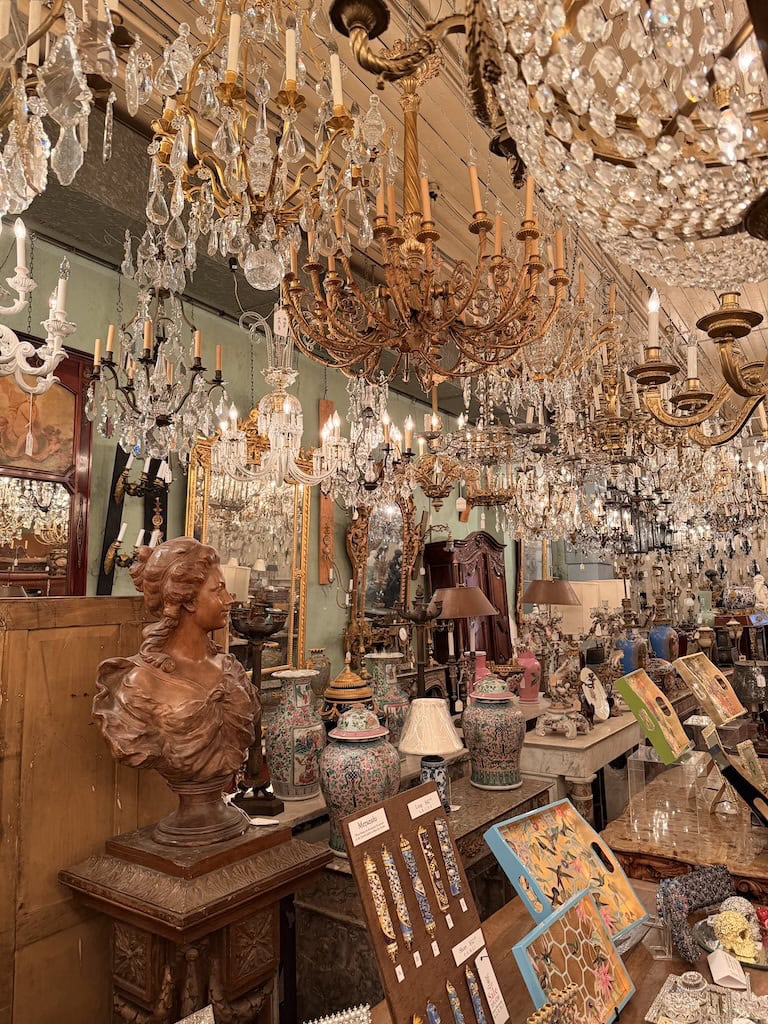 Luxurious antique chandeliers hanging in a vintage decor store.