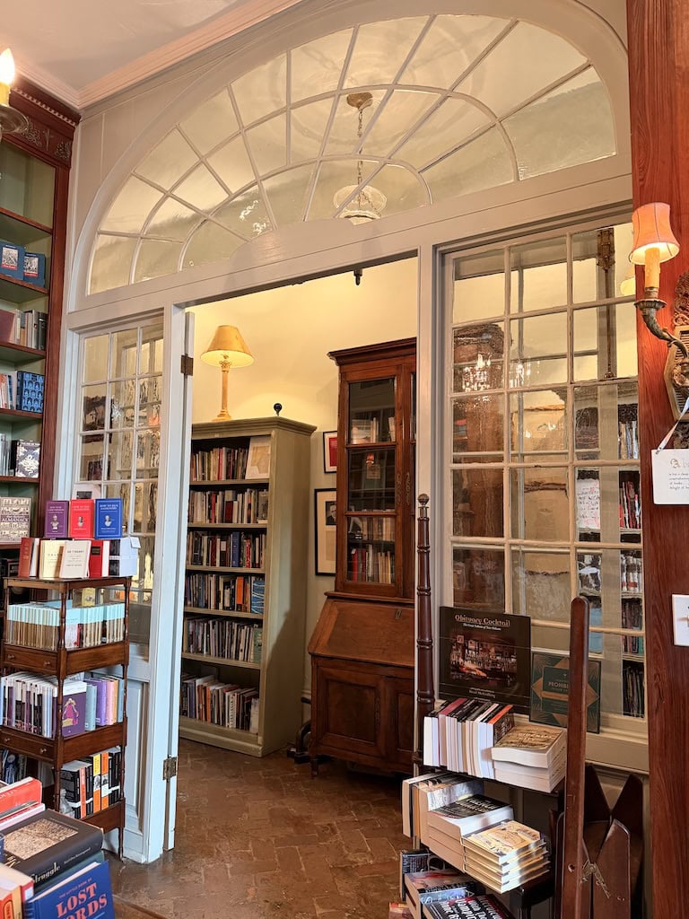 Charming bookstore with wooden shelves, books, and warm lighting.
