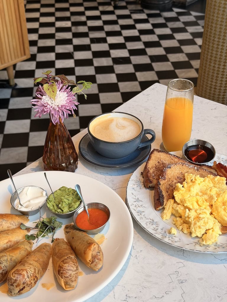 Breakfast with coffee, orange juice, pastries, and condiments at Le Travel Style.
