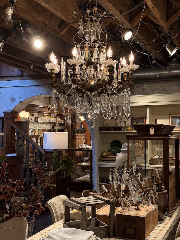 Luxurious vintage interior featuring a grand crystal chandelier and antique decor.